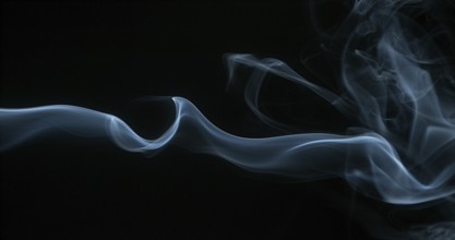 Smoke of Cigarette rising against Black Background