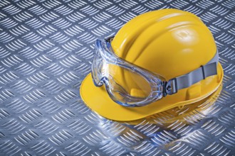 Safety goggles Safety helmet on fluted metal background Construction concept