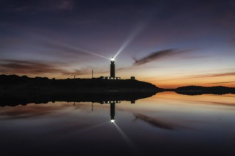 A view of the Cape Trafalgar lighthouse signal light after sunset with colorful evening sky