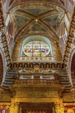 Siena Italy, October 25, 2018: Wall, stained-glass window and ceiling decorations in Siena