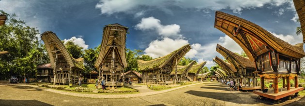 Panoramic photo of tongkonans with saddleback roofs and small square in Kete Kesu, Toraja region in