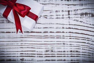 Gift box on vintage wooden board holiday concept