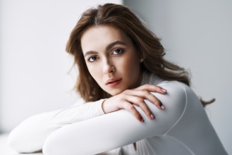 Close up portrait of sensual pretty young woman. Beautiful female model in white cloth with clean