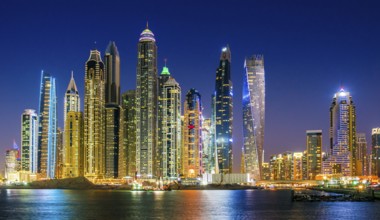 Modern residential architecture of Dubai Marina, United Arab Emirates. City skyline by night