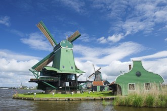 Green windmill at the Dutch Zaanse Schans near the river