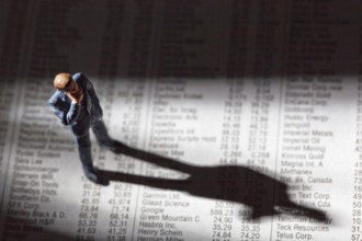 A small figure and the prices of shares in a newspaper. Earning money on the stock market. Profits