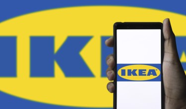 The logo of the IKEA store on the screen of a smartphone.