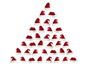 Isolated fluffy red Santa's hats over white