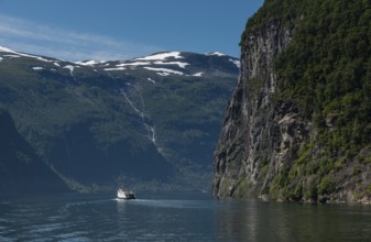 People on cruise boat at the famous geiranger fjord waterfalls in norway