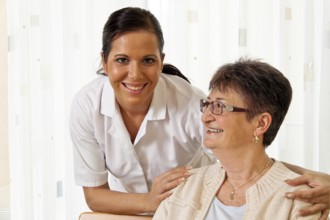 A carer caring for the elderly in a retirement home