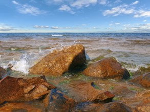 Coastline of the sea with rocks and blue sky over it