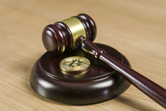 Photo of Bitcoin Regulation. BTC crypto coin and gavel on a desk