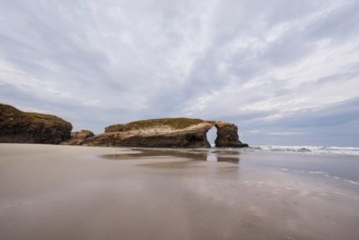 Natural rock arch in beach of Cathedrals in Lugo, Galicia, Spain, Europe
