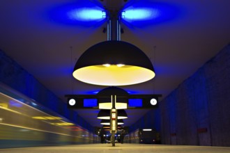 Underground station with arriving trains and symmetrical yellow lights
