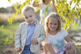 Little boy in a suit on the background of his sister