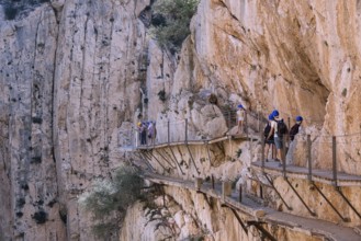 El Chorro, Spain, April 2023: People walking the Caminito Del Rey in the Desfiladero de los