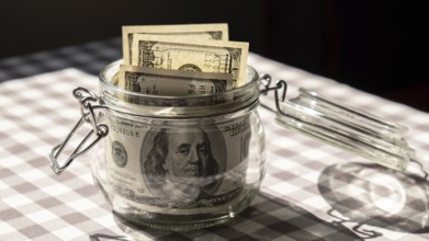 Dollar banknote saving money in glass jar. Consumption and economy Collecting money. Tips.