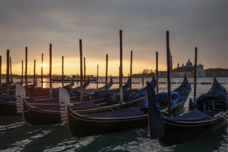 Morning atmosphere at sunrise, gondola jetty, San Giorgio Maggiore church behind, Venice, Veneto,