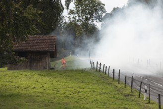 Track marshals in the fog at the 1st Malters hill climb in Malters, Lucerne, Switzerland, Europe
