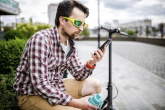 Caucasian man uses modern technologies Internet and cellular communication on smartphone while