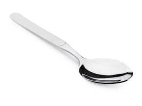 Single soup spoon over the white background