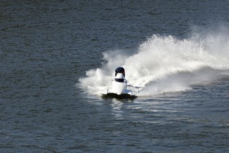 White Speedboat Making Turn with Splashes of Water during Race on Championship