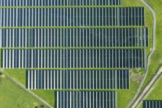 Solar panels on field in summer, aerial drone view