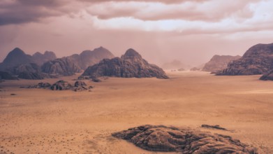 Storm and rain clouds over the desert landscape of Wadi Rum in Jordan. Panoramic shot 16:9 aspect