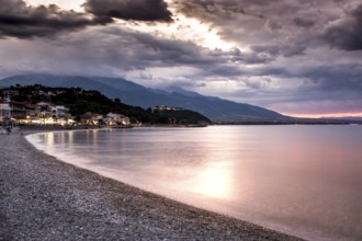 Beautiful seascape, amazing view of pebble coastline in mild sunset light, romantic evening on the