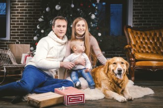 Theme Christmas and New Year family circle and domestic pet. Mom dad and child 1 year old Caucasian
