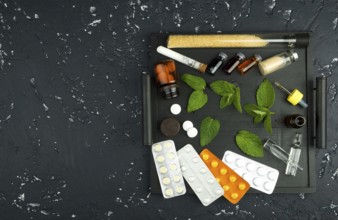 Fresh mint and drugs on the board. View from above. Copy space