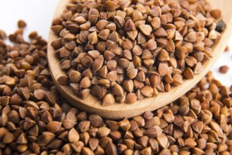 Buckwheat seeds on wooden spoon in closeup, lodz, poland