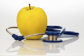 A stethoscope and an apple. Symbolising healthy nutrition. Austria