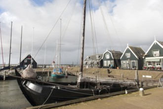Groene houten huizen in het haventje van Marken