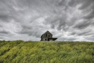 Abandoned Farm with storm clouds in the Canadian Prairie