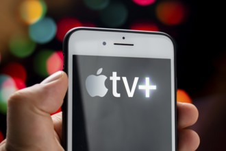 Calgary, Alberta, Canada. May 21, 2020. A person holding a white iPhone Plus with the Apple TV Plus