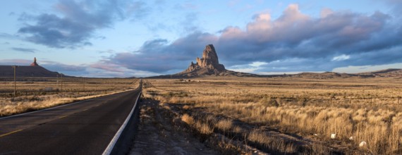 Scenic clouds above a straight road through Navajo Nation, USA, North America