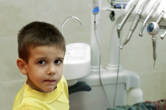 Child in a dentist's chair in cabinet