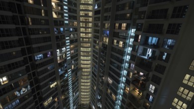 Lights in the windows of high-rise apartment block at night. Kuala Lumpur, Malaysia, Asia