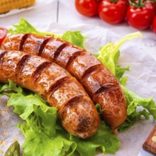 Grilled krakauer sausage with boiled corn and green salad