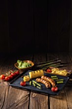 Grilled krakauer with french fries and green salad