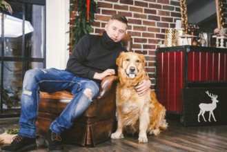 The theme is the friendship of man and animal. Caucasian young male and pet dog breed Labrador