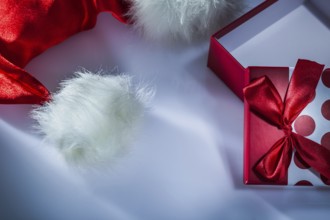 Santa cap wrapped gift box on white background
