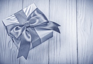 Packaged gift box on wooden board top view holidays concept