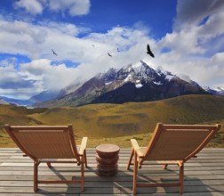 Pleasant holiday. Chile. Wooden chairs in the park Torres del Paine. On the horizon is visible