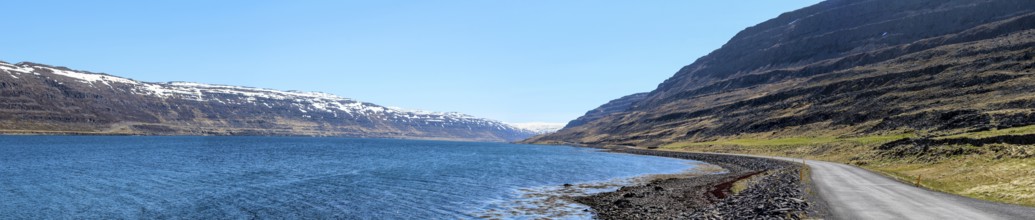 Panoramic view of a gravelled road at a fjord, Westfjords of Iceland