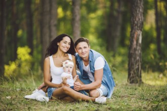 The theme family outdoor recreation in forest park area. Young beautiful stylish caucasian family