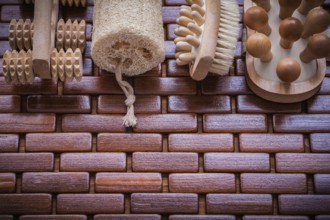 Wood scrubbing brush massagers and loofah on textured wooden place mat healthcare concept