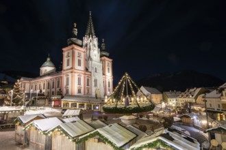 Christmas market in front of the basilica on the main square, night shot, Mariazell, Upper Styria,