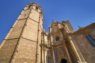 Valencia Cathedral main door and Miguelete tower at Plaza de la Reina sq Spain